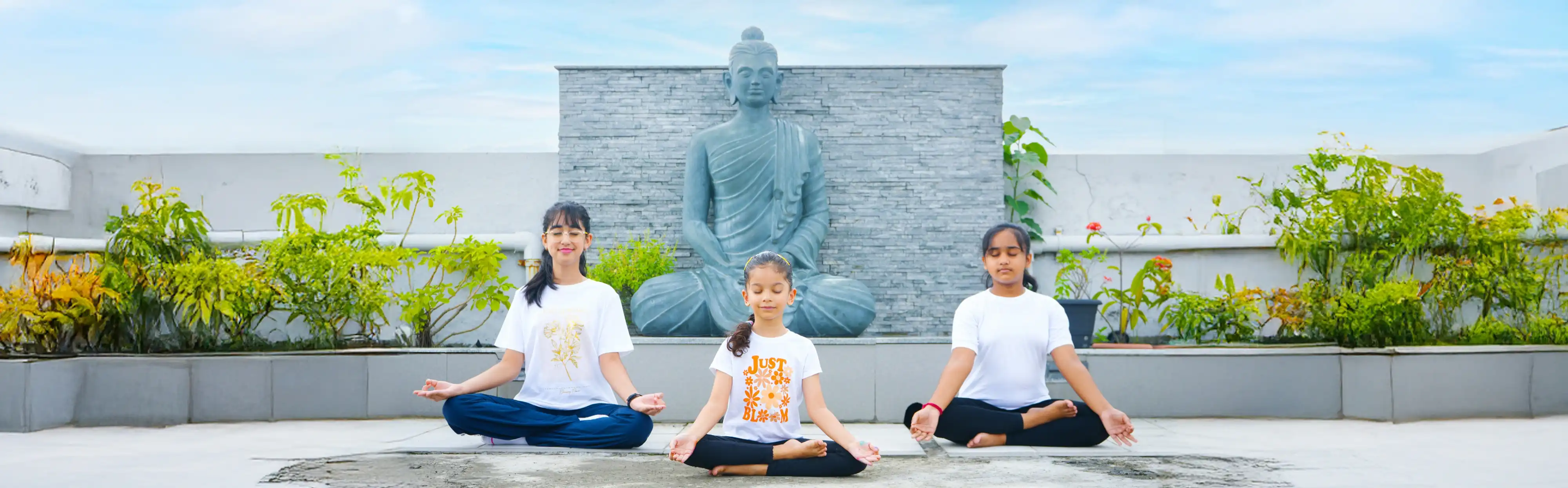 A focused child practicing calming yoga exercises at home during an engaging online yoga beginners course, seamlessly guided by Gaurav Tribedi at Nabatara.